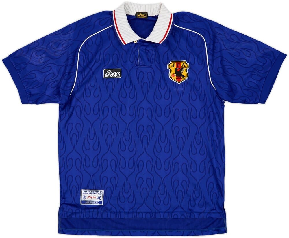 Japan 1998 home shirt, front: blue with an all-over tonal flame pattern, a white polo collar with red trim, the ASICS logo and the JFA crest.