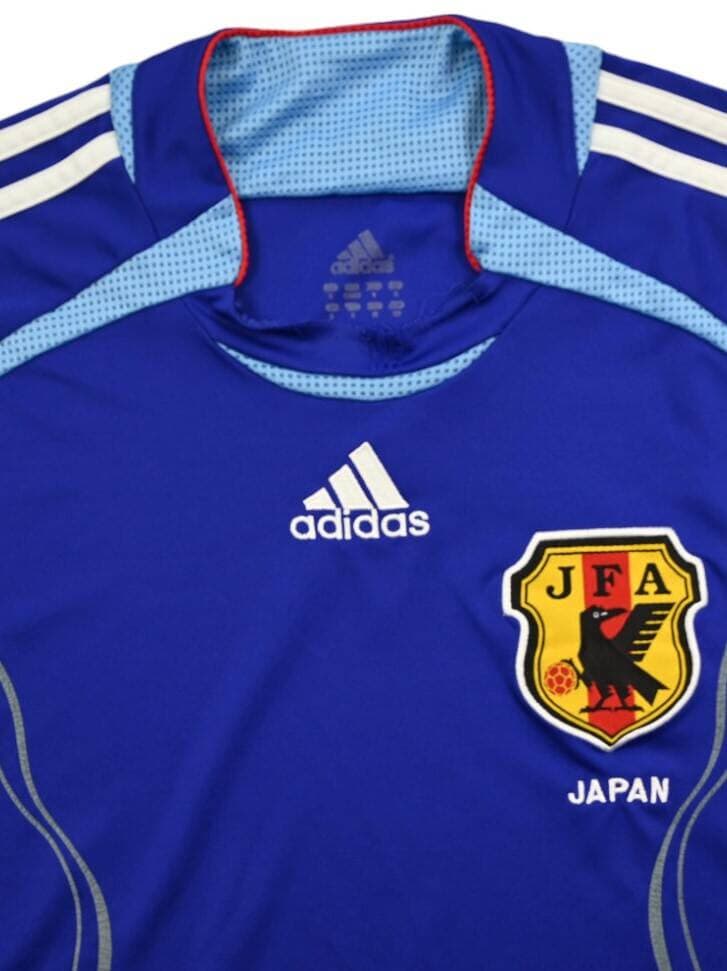 Japan 2006 home shirt detail: the JFA Yatagarasu crest and the adidas logo on the blue body.