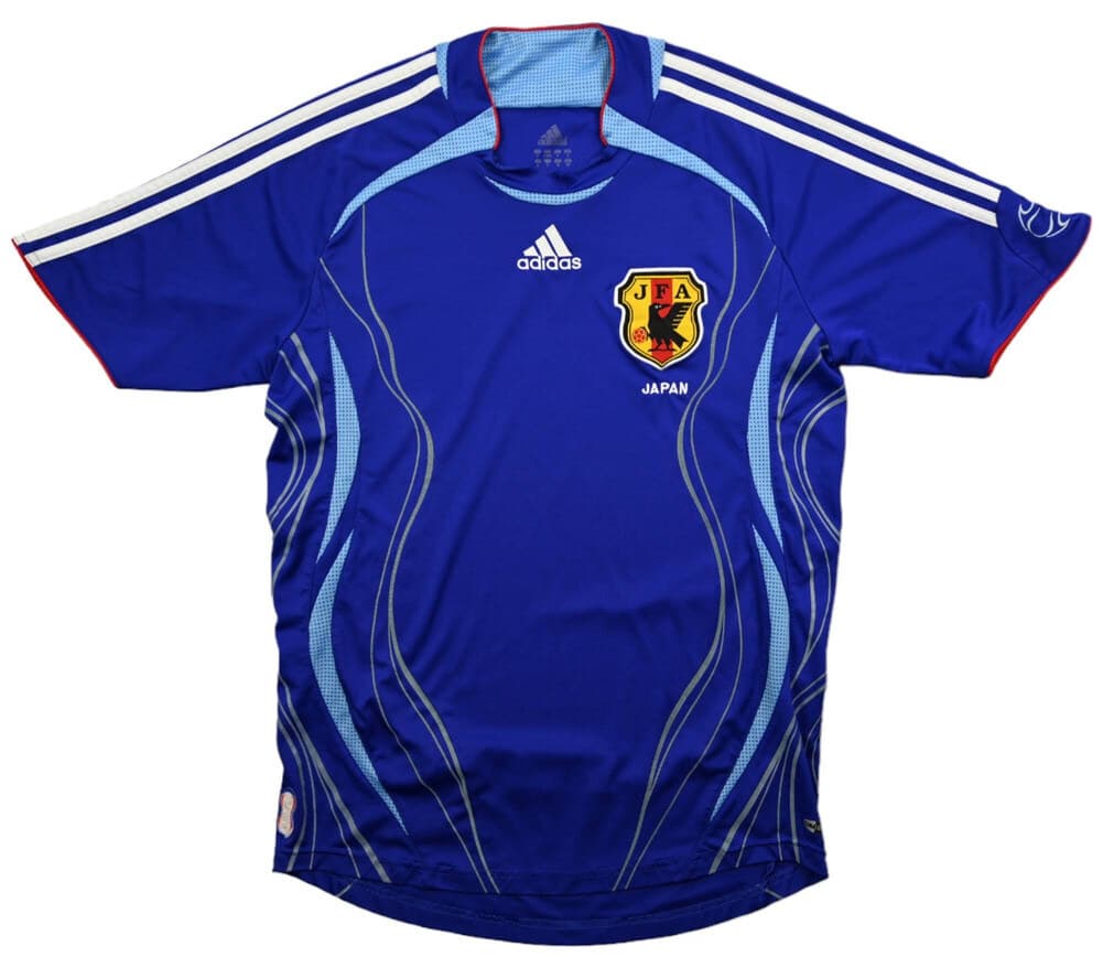 Japan 2006 home shirt, front: blue with light-blue wave graphics up the sides, white adidas stripes, red trim and the JFA crest.