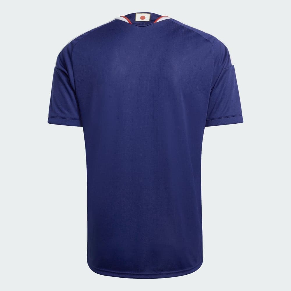 Japan 2026 home shirt, back view: plain Japan Blue with the Hinomaru (Japanese flag) set inside the back collar.