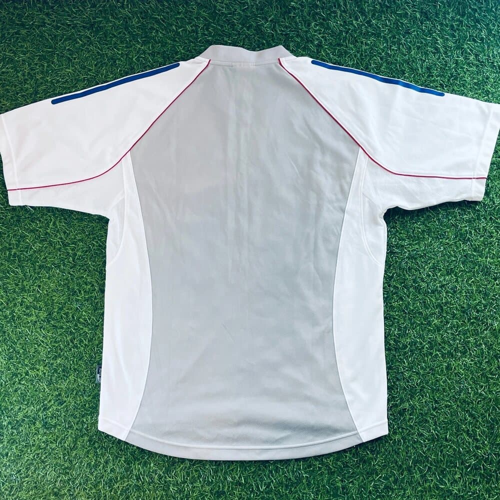 Japan 2002 away shirt, back: white with blue adidas shoulder stripes and red and blue trim.