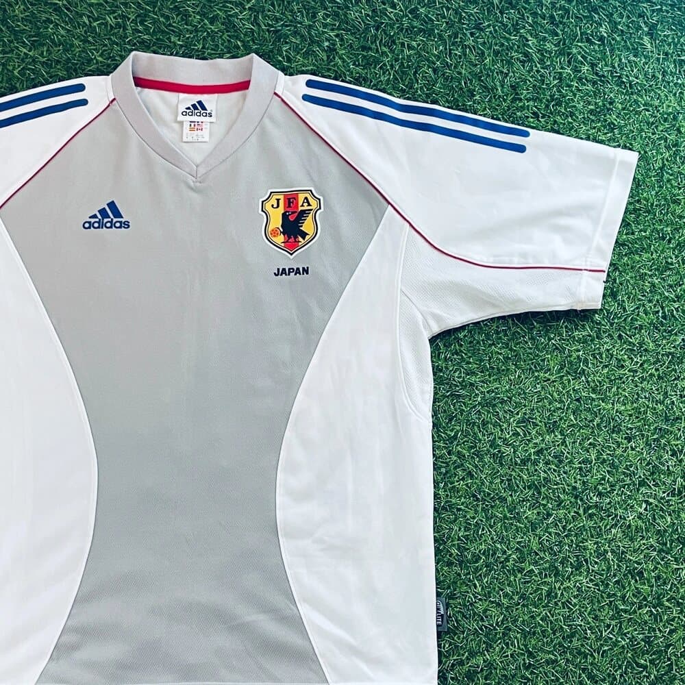 Japan 2002 away shirt detail: the JFA Yatagarasu crest and the adidas logo on the white body.